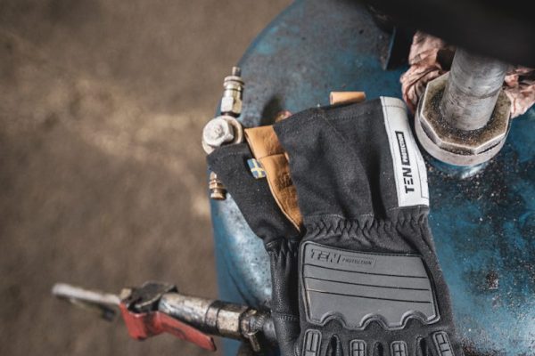 a pair of gloves sitting on top of a blue object