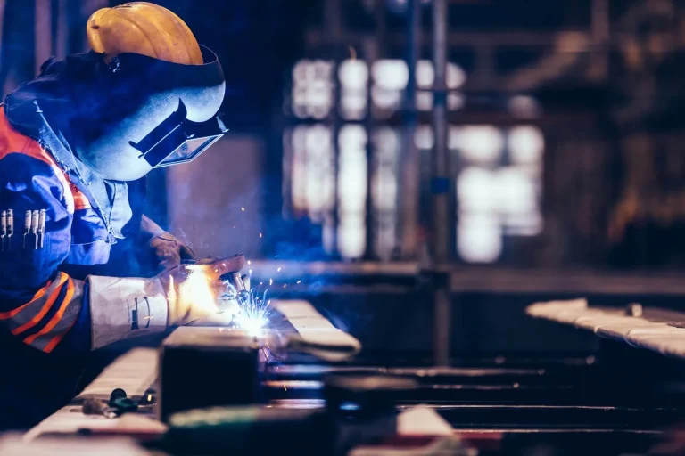 Welder working at a bench in a workshop