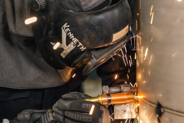 Worker grinding metal with sparks